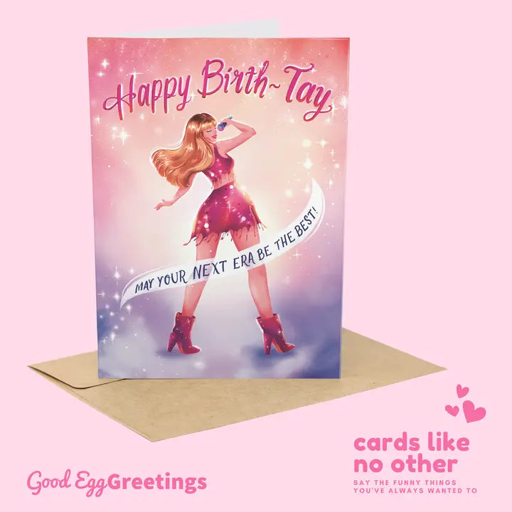 Good Egg Greetings Birthday card with a stylized illustration of a Taylor Swift on a pink background, featuring the brand 'Good Egg Greetings'.